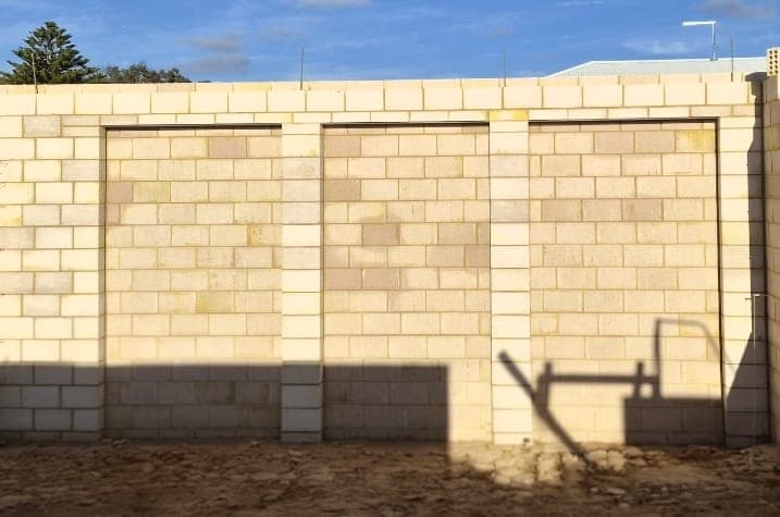 Completed panelled boundary wall showing consistent coursing and joint work